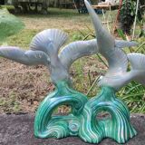 Old barbotine statue seagulls on the wave