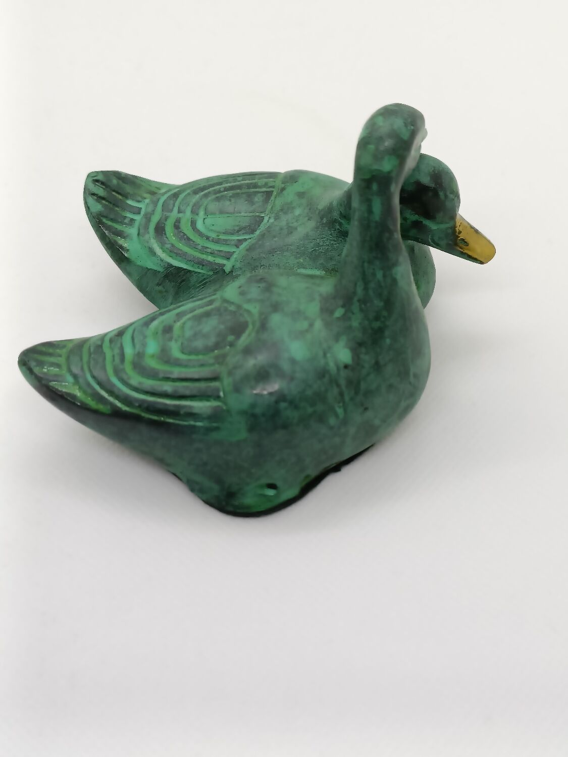 Two green and golden ducks in brass