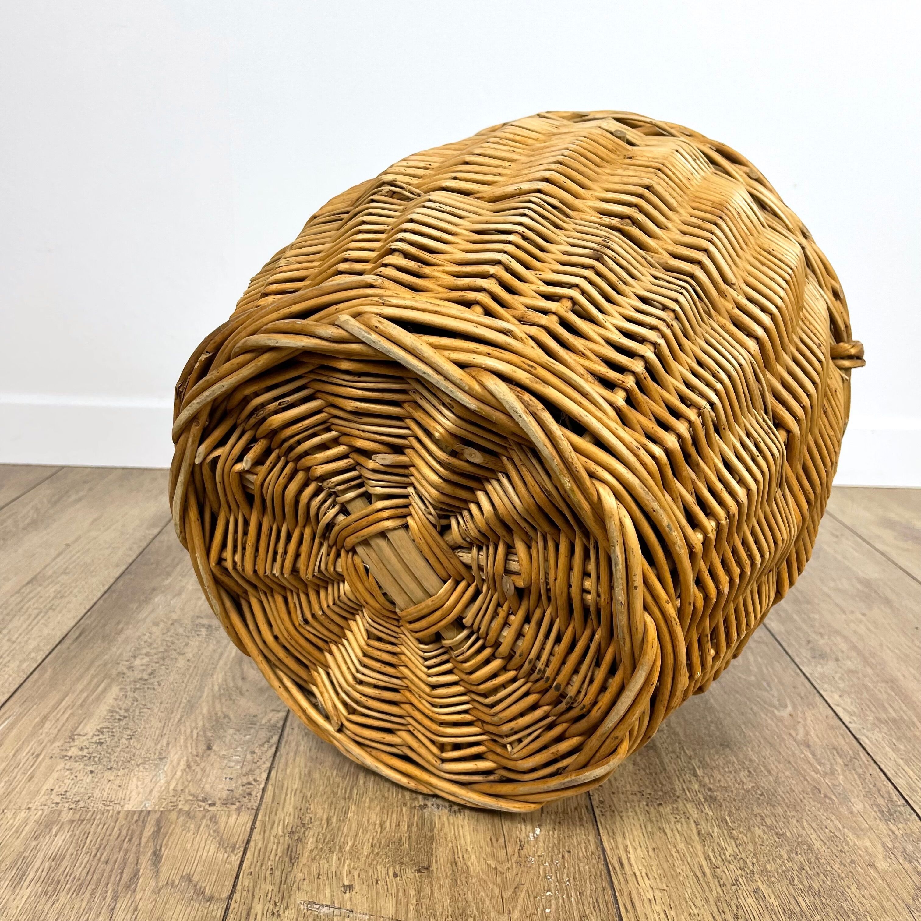 Old demijohn in her wicker basket