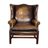 Patinated cowhide leather armchair