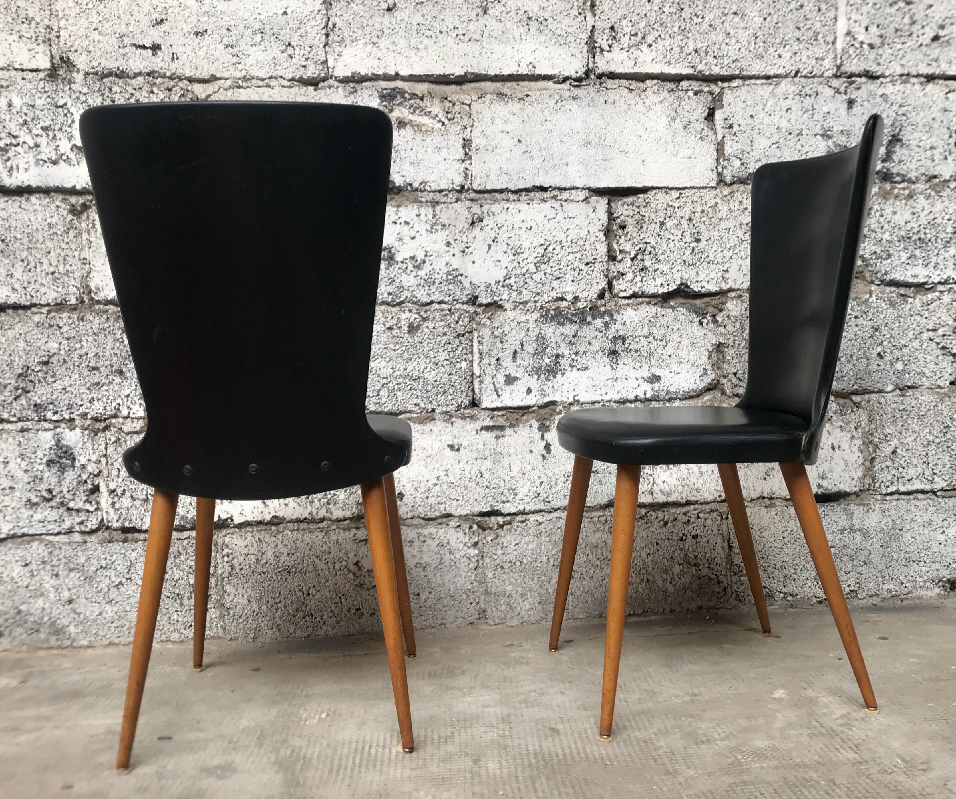 Pair of Baumann model Essor chairs in faux black leather, beech compass footing