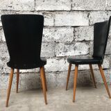 Pair of Baumann model Essor chairs in faux black leather, beech compass footing