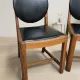 Set of four vintage wooden dining chairs with black leather upholstery, 85 × 45 × 45 cm