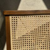 Reclined armchair in canned teak in natural wood
