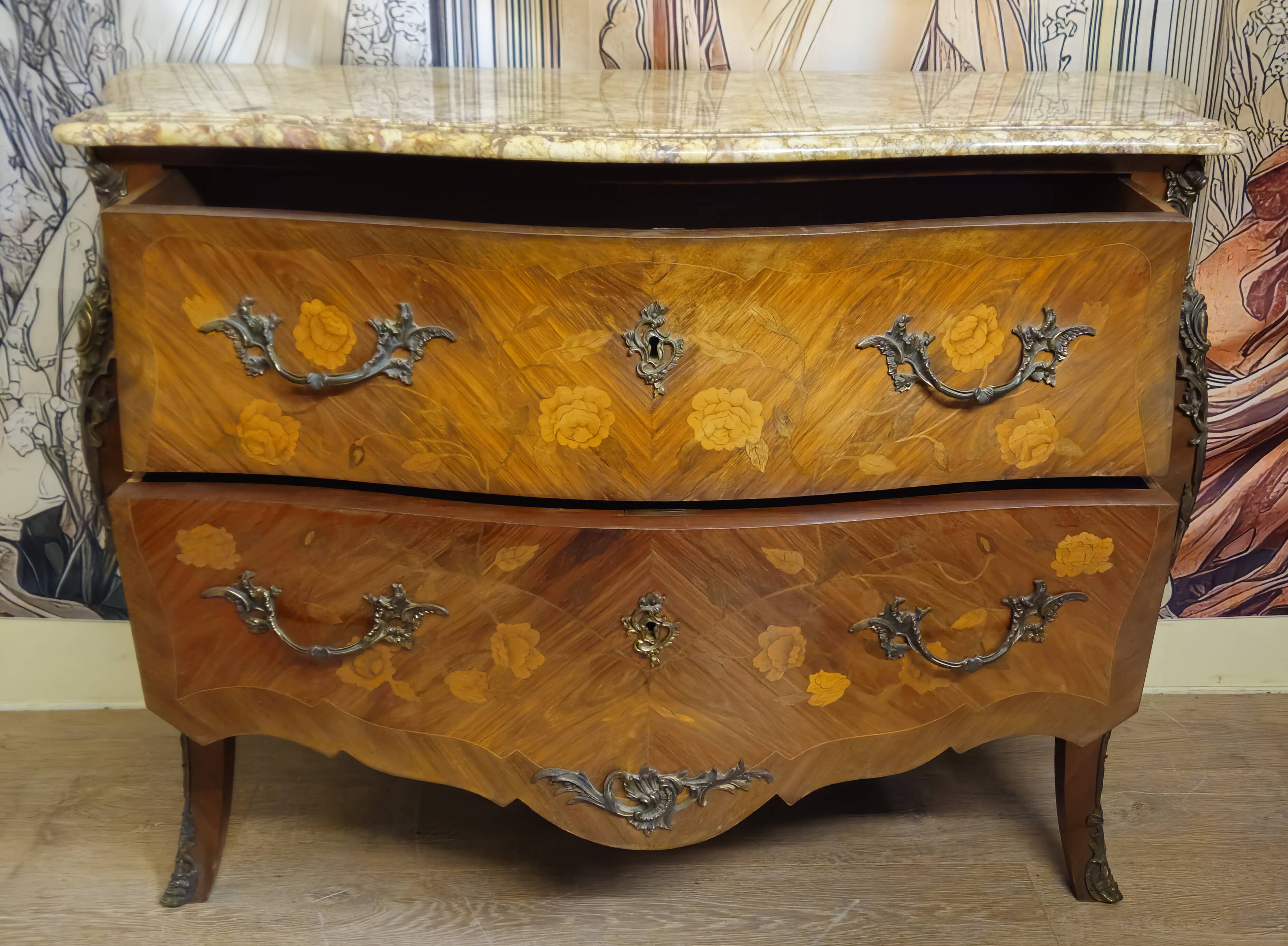 Curved Louis XV style commode with floral marquetry and marble top.