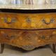 Curved Louis XV style commode with floral marquetry and marble top.