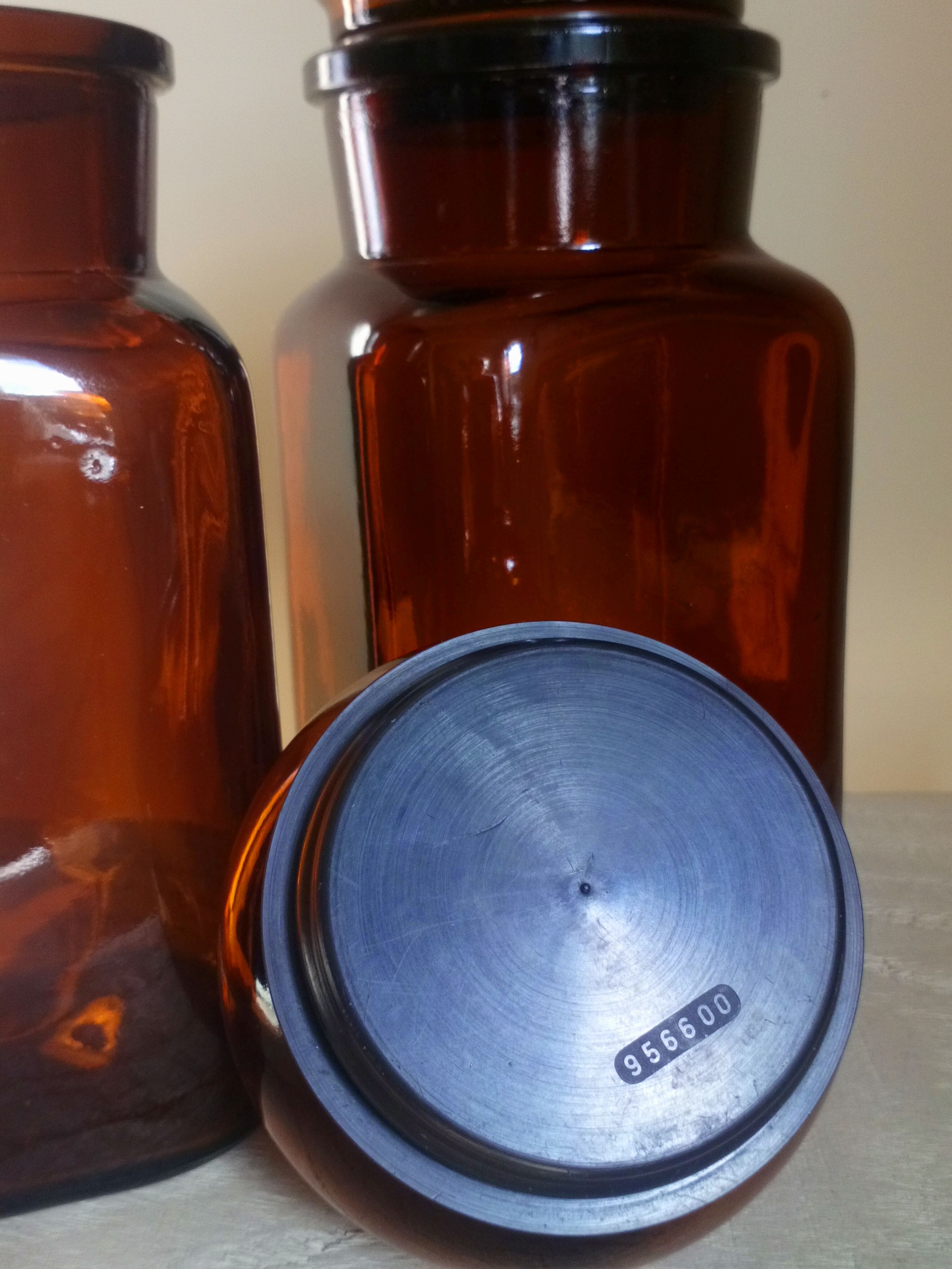 Duo of vintage apothecary bottles in amber glass