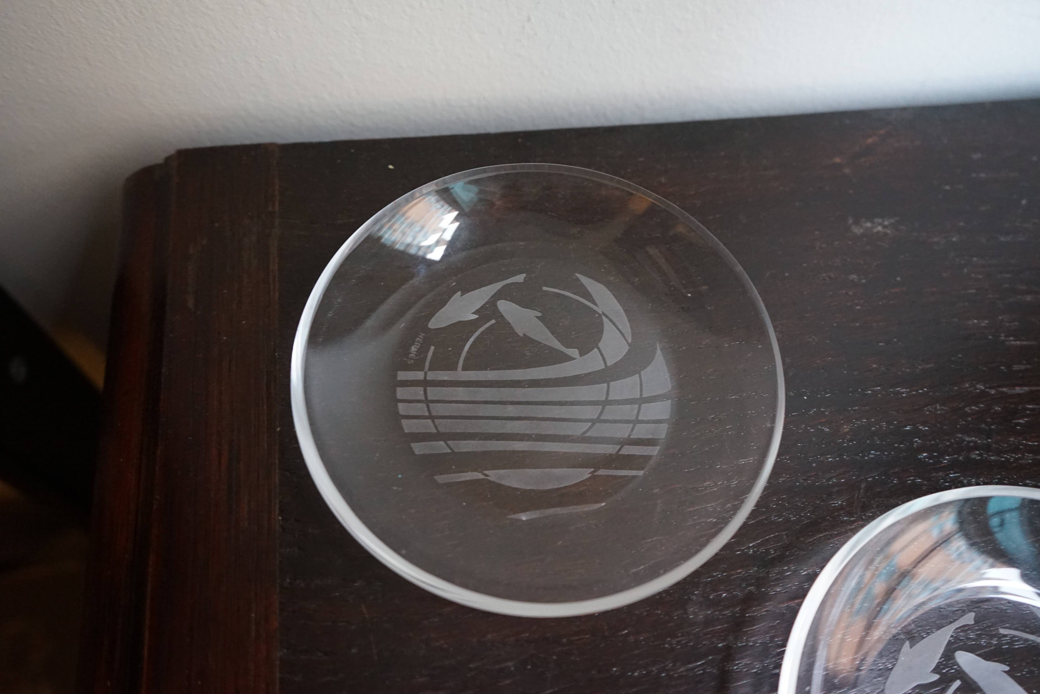 Hermès pair of glass plates with a dolphin pattern.