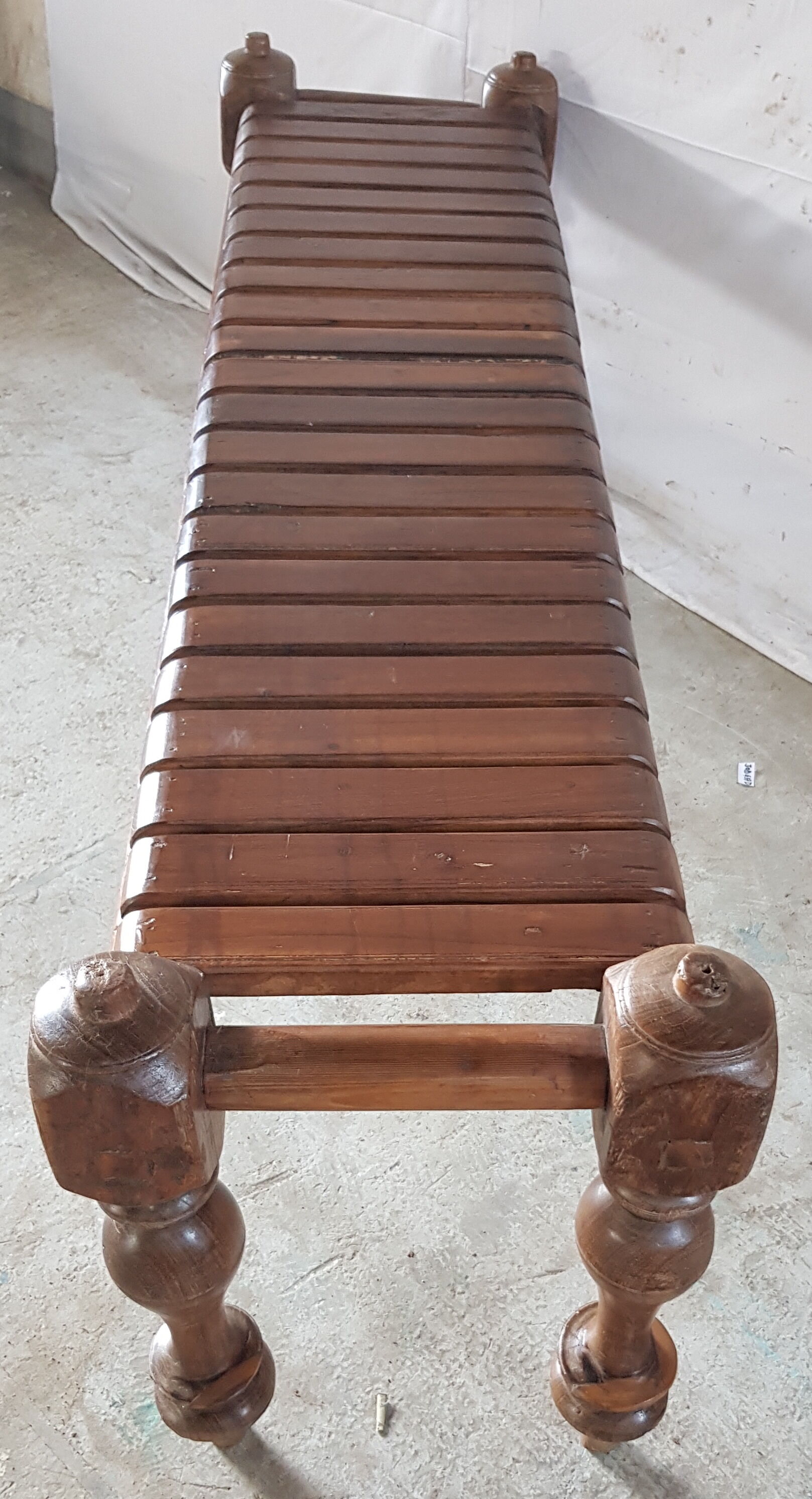 Bench with slats and feet of charpoy beds in teak