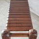 Bench with slats and feet of charpoy beds in teak