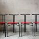 Set of 4 vintage black metal chairs with red lacquered seats.