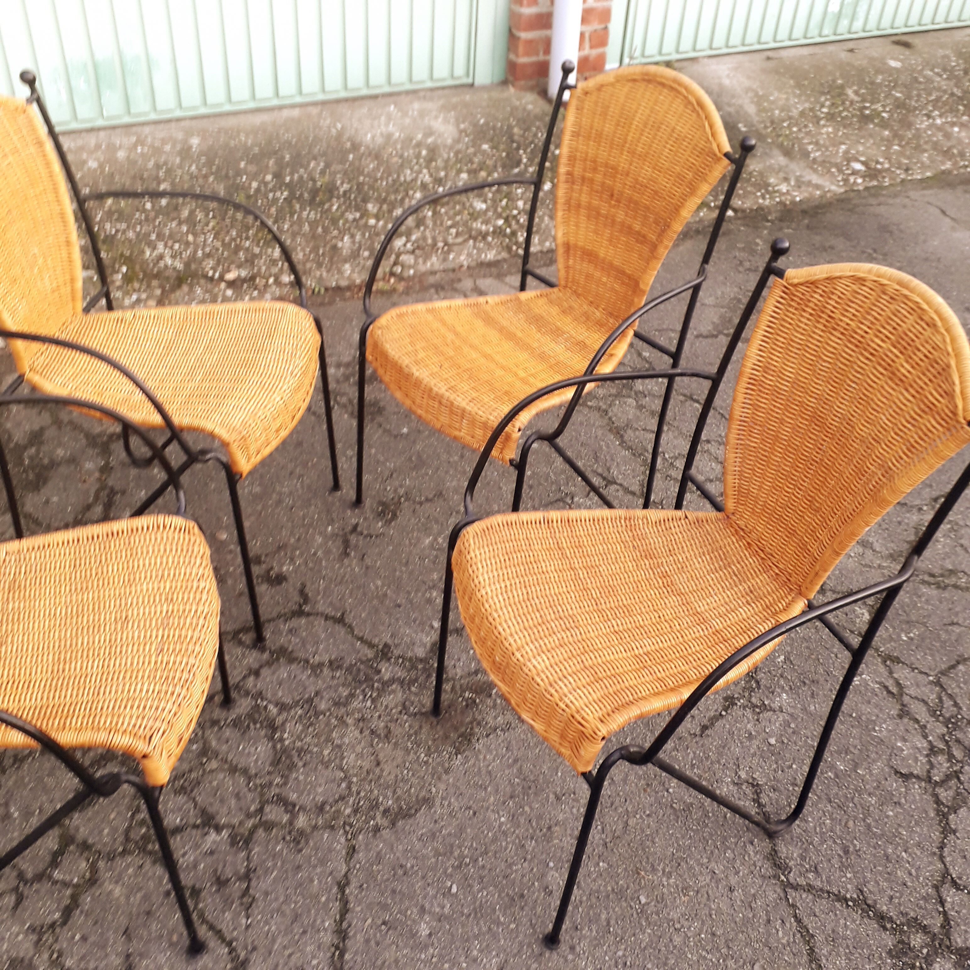 4 vintage wrought iron rattan chairs.