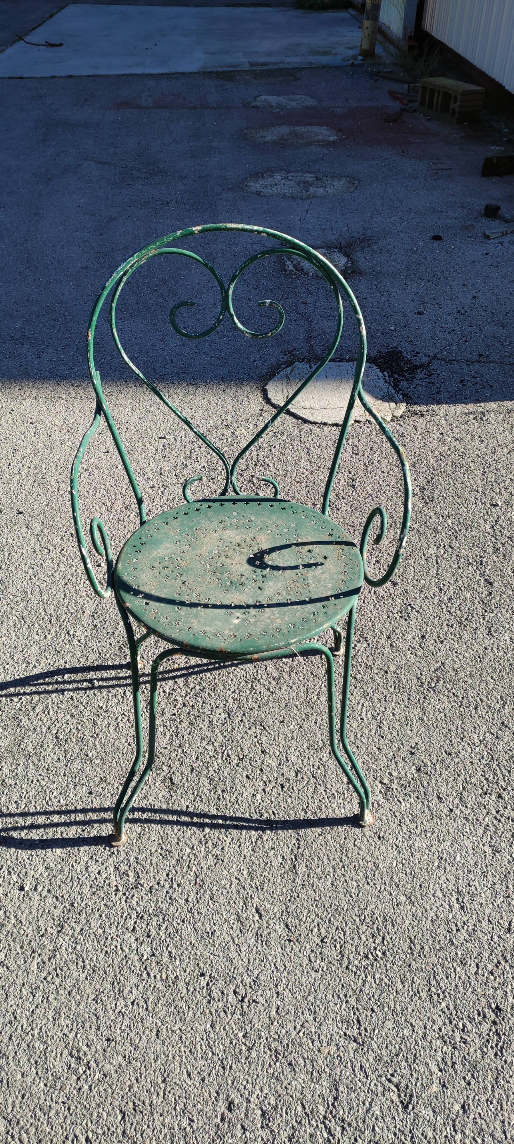 Garden table, two armchairs and a metal chair