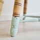 Antique tripod stool with striped seat.