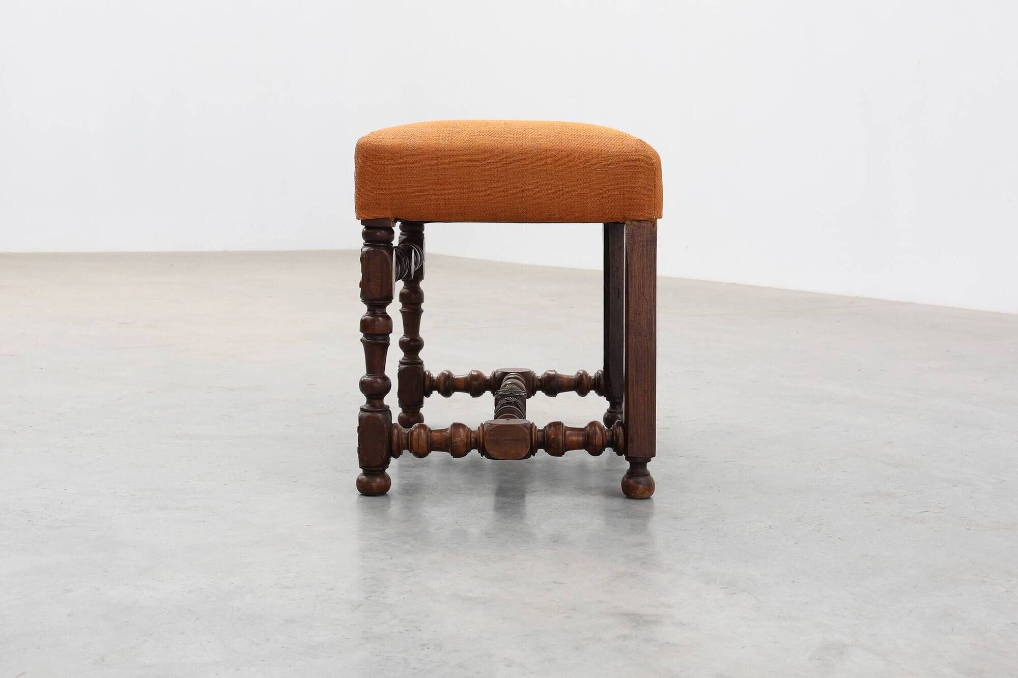 Louis XIII walnut stool with carved turned stretchers and upholstered seat