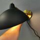 A wall lamp in black and brass-coloured finishes. Danish, early 2000s.