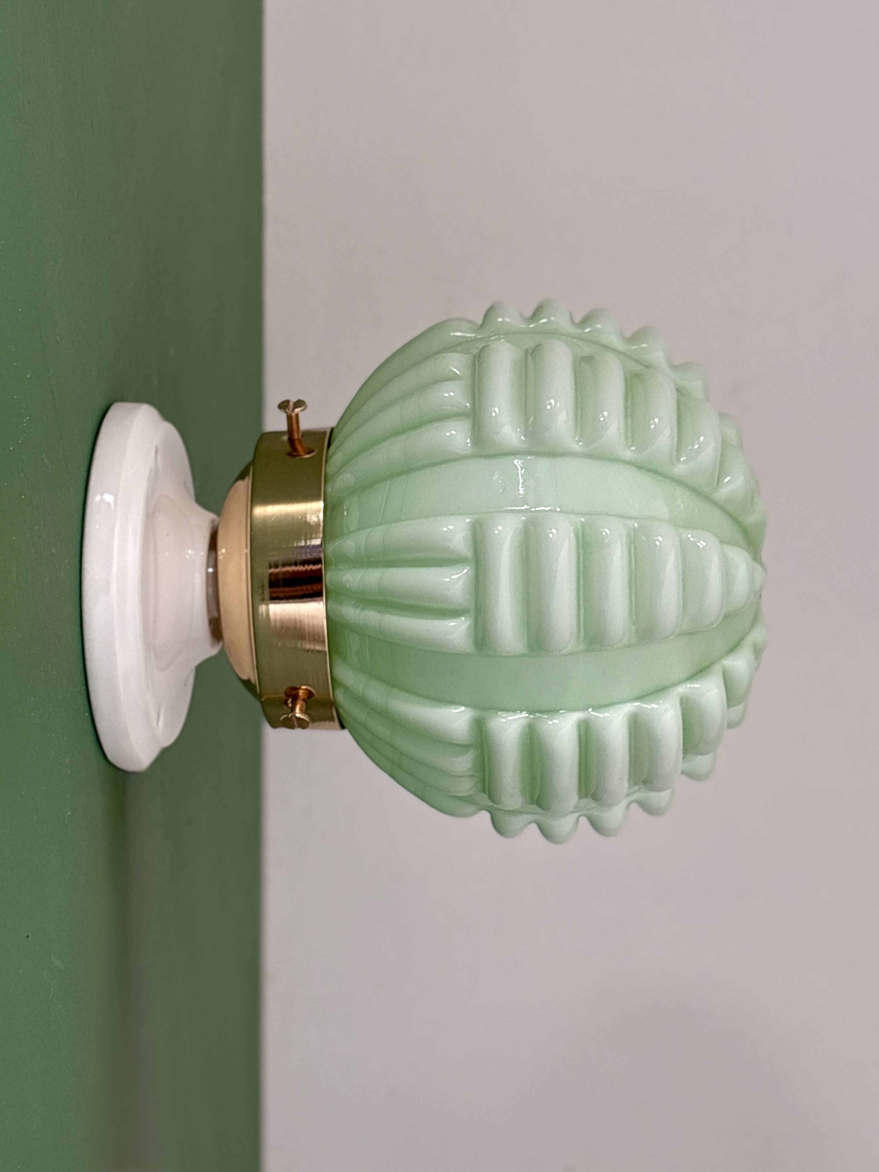 Vintage Art Deco globe wall light in pale green opaline.