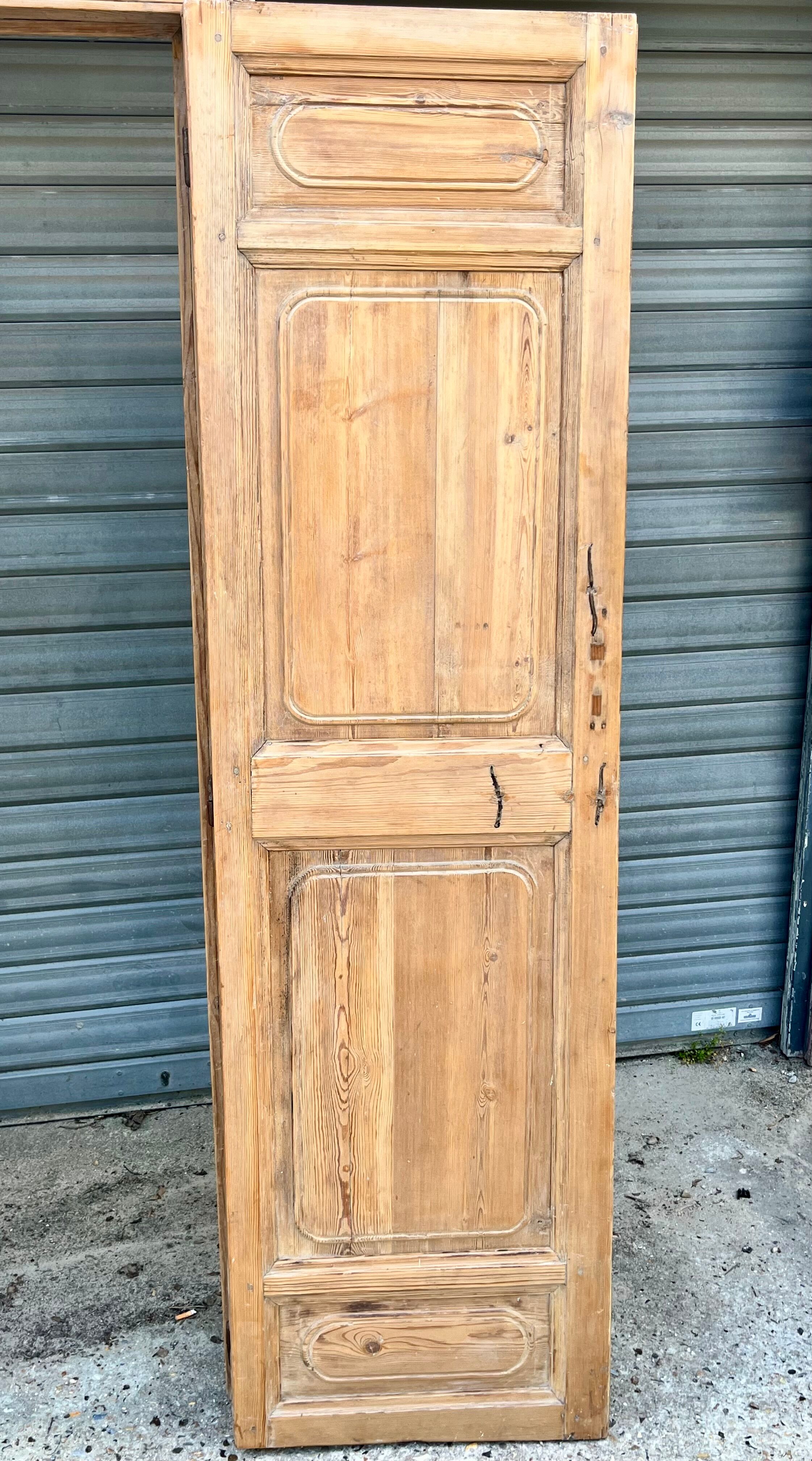 pair of old double-leaf doors with transom and carved frames