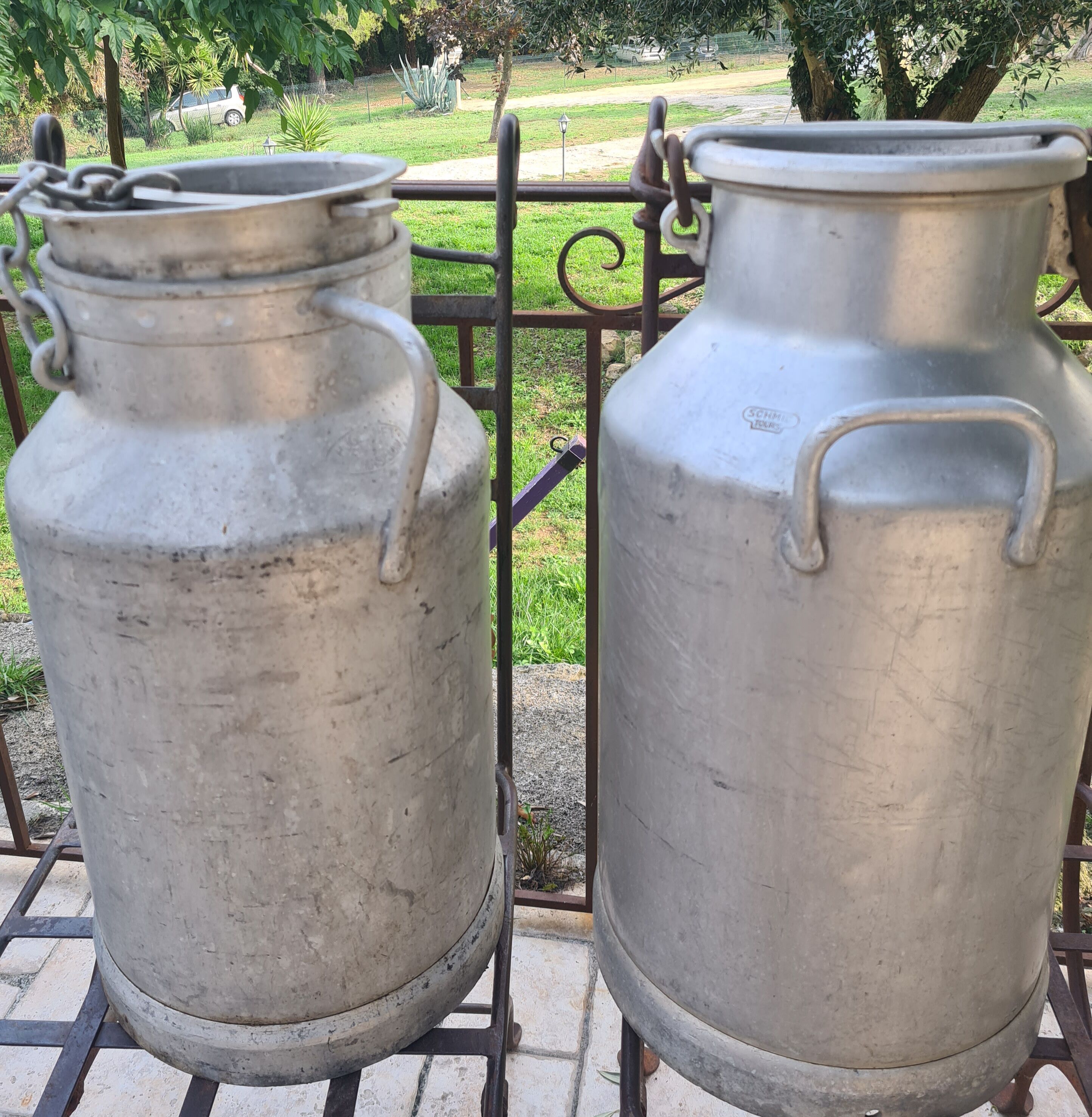 set of 2 old aluminum milk jugs
