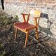 Old wooden and red leatherette bridge chair