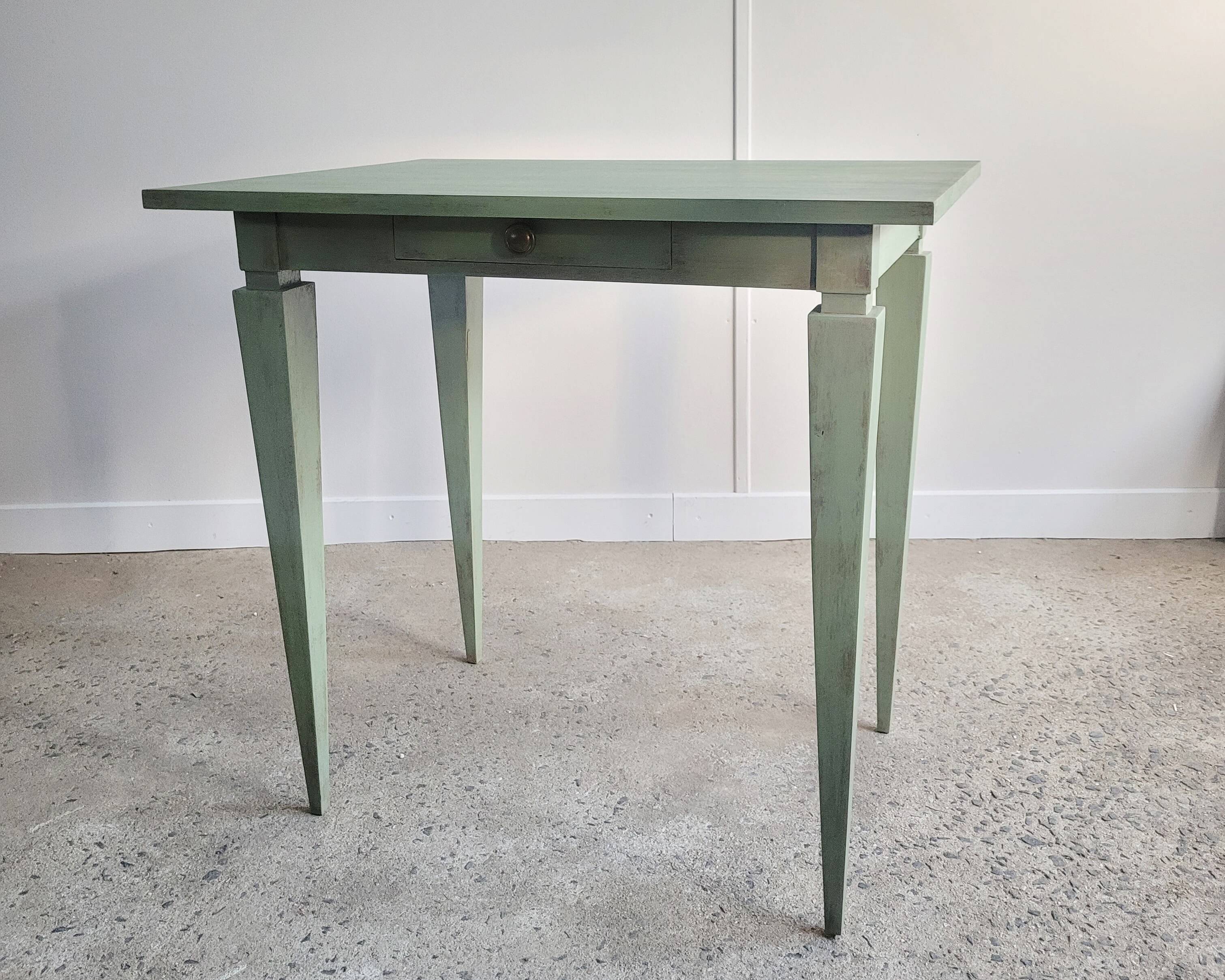 Green side table with tapered legs