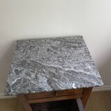 Vintage bedside table in the shape of a wooden column and a gray marble top