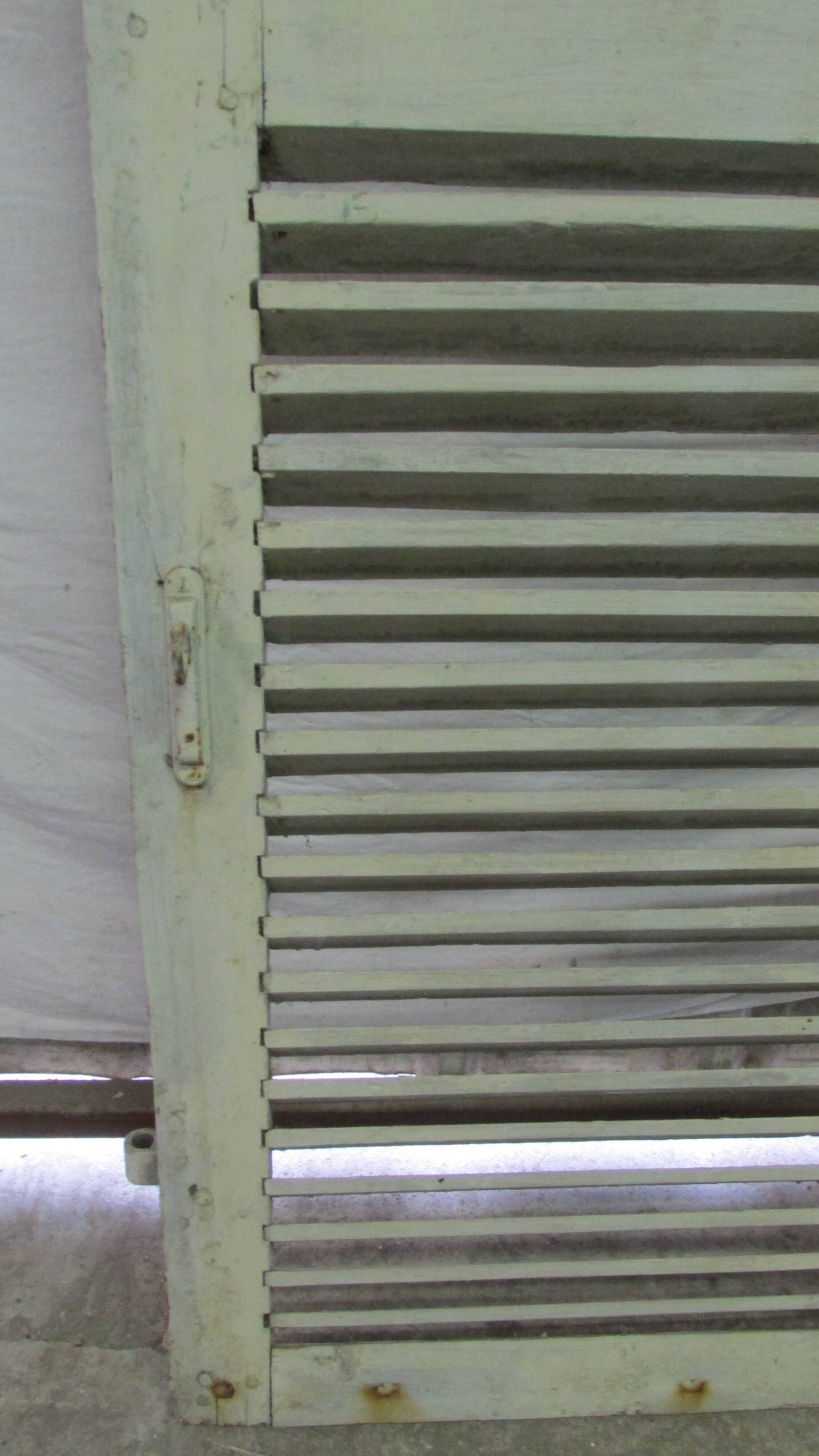 Old wooden shutter with perforations.