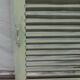 Old wooden shutter with perforations.
