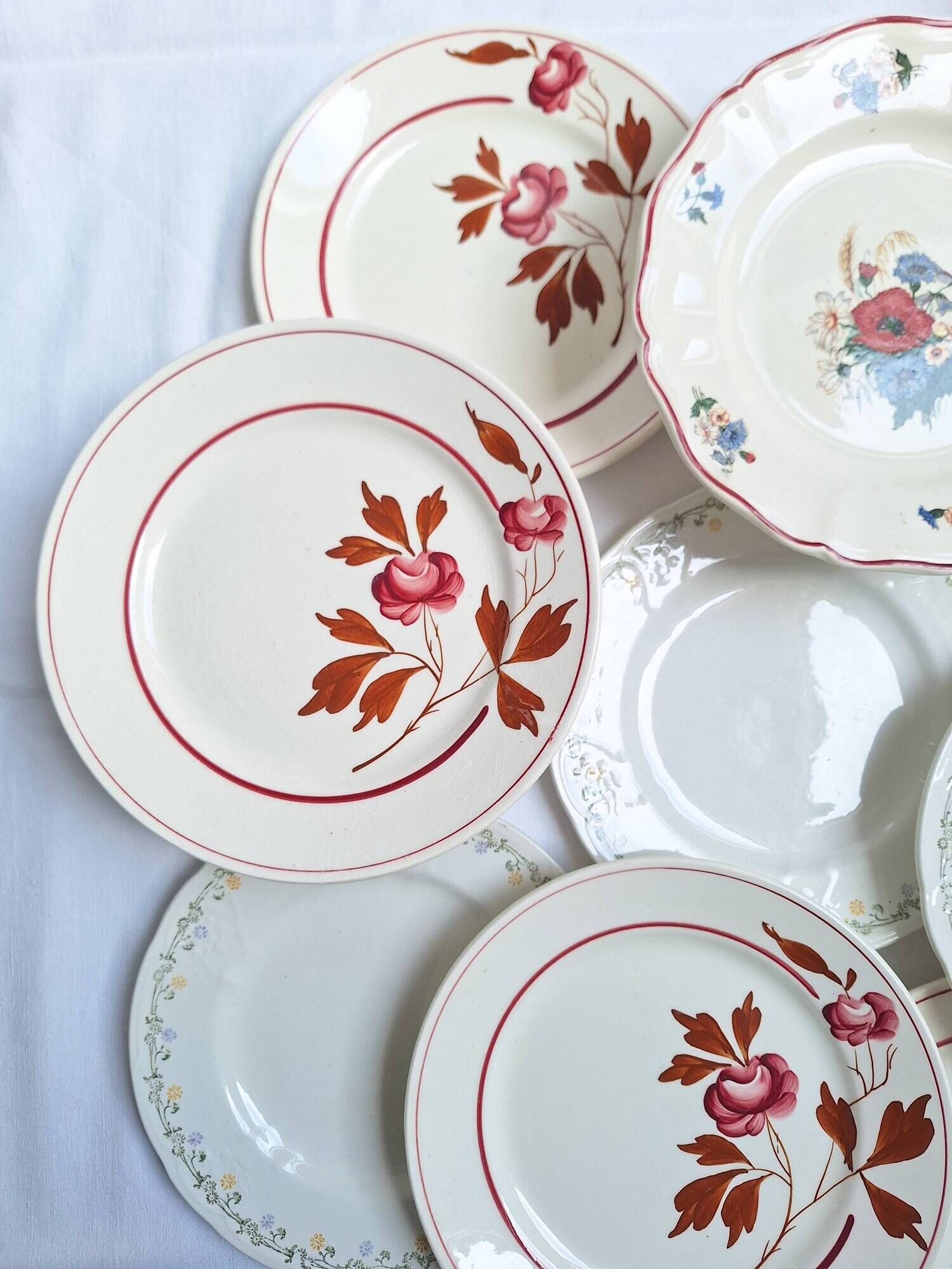 Vintage flower dessert plates from Sarreguemines, Longwy, and Lunéville.