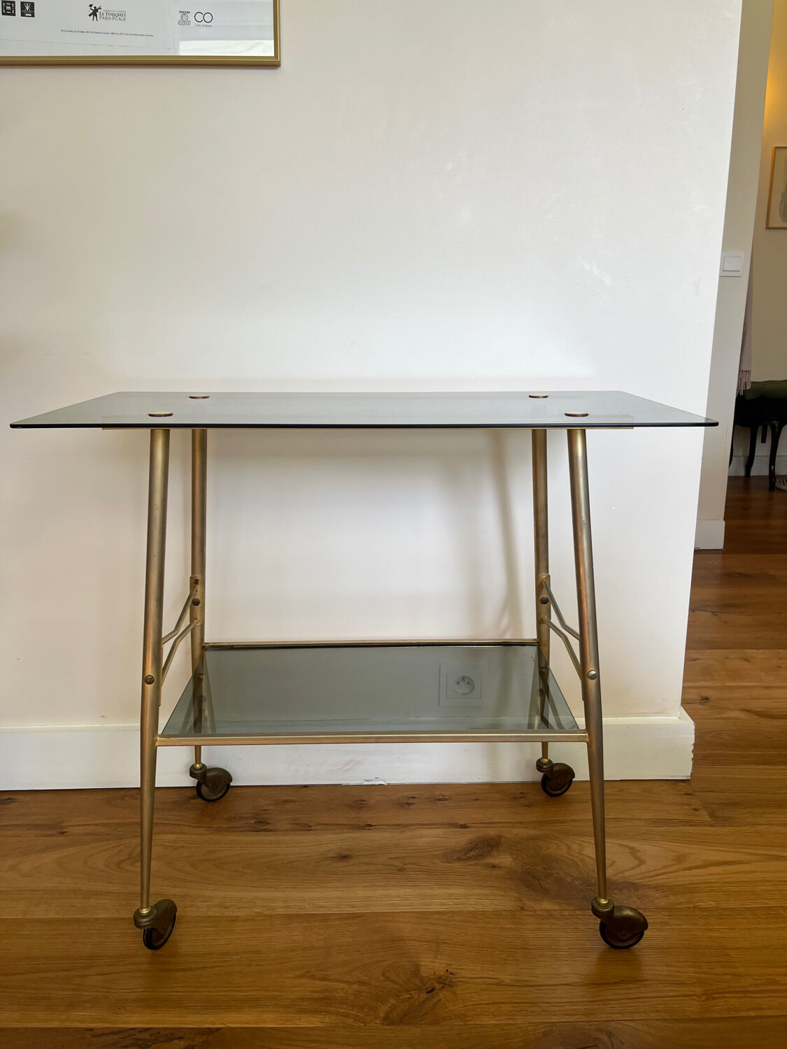 Vintage brass and smoked glass dessert trolley on wheels.