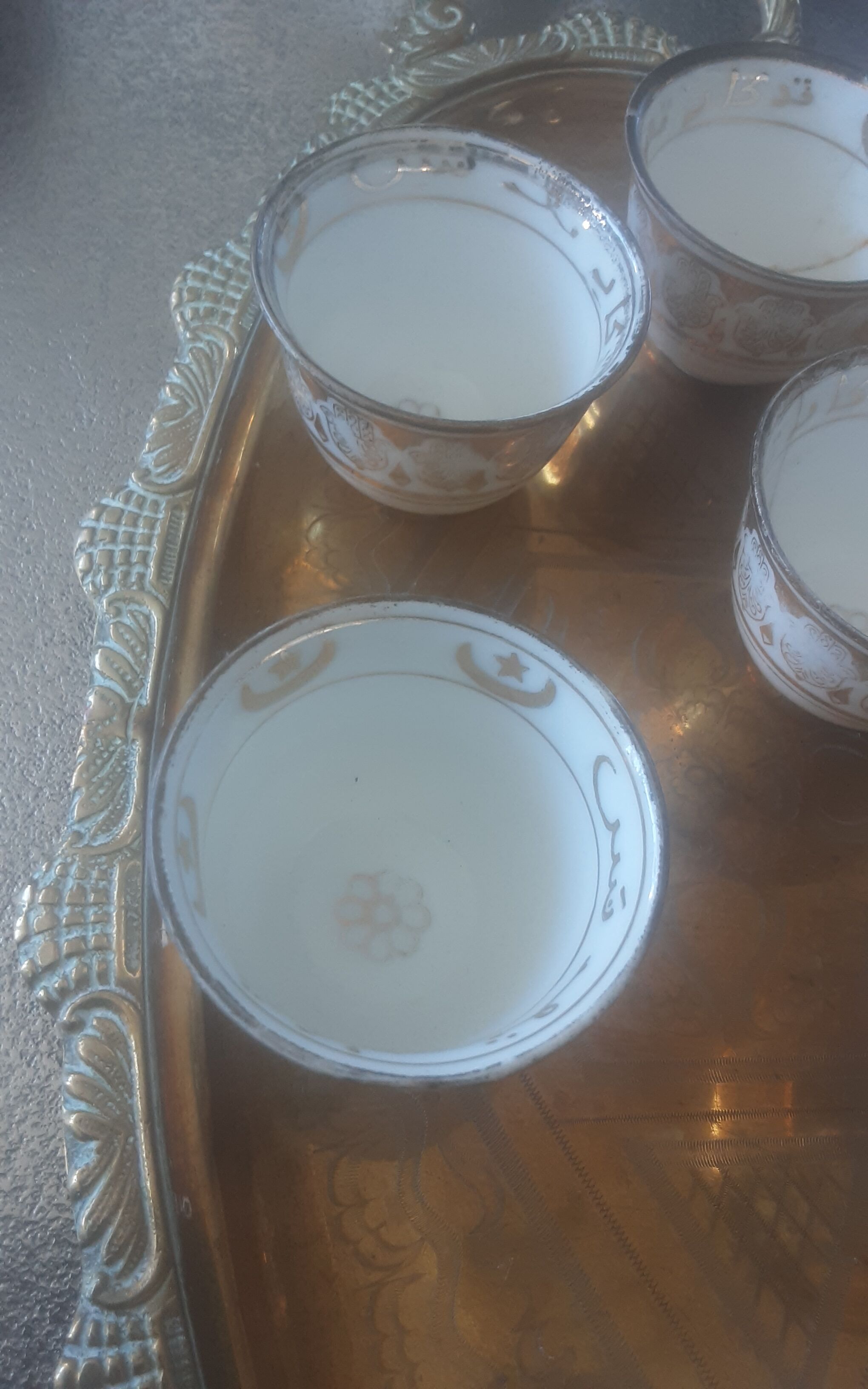 Old service porcelain brass cups