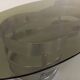 Vintage oval coffee table in smoked glass and chrome metal from the 1970s.