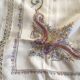 Grey silk nape and towels embroidered with coloured cashmere patterns