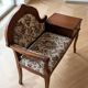 Antique wooden telephone bench in dark brown.