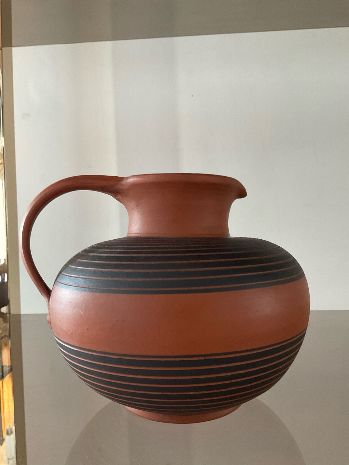 Vintage jug in chiseled terracotta