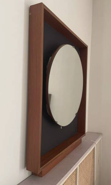Scandinavian mirror with wooden frame and backlighting.