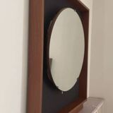 Scandinavian mirror with wooden frame and backlighting.