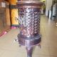 Old compact wood stove in enamelled cast iron with tripod feet with Lion's legs