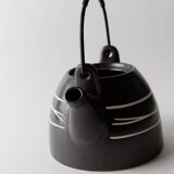 Vintage ceramic teapot from the 1980s, black with white stripes and a metal handle.