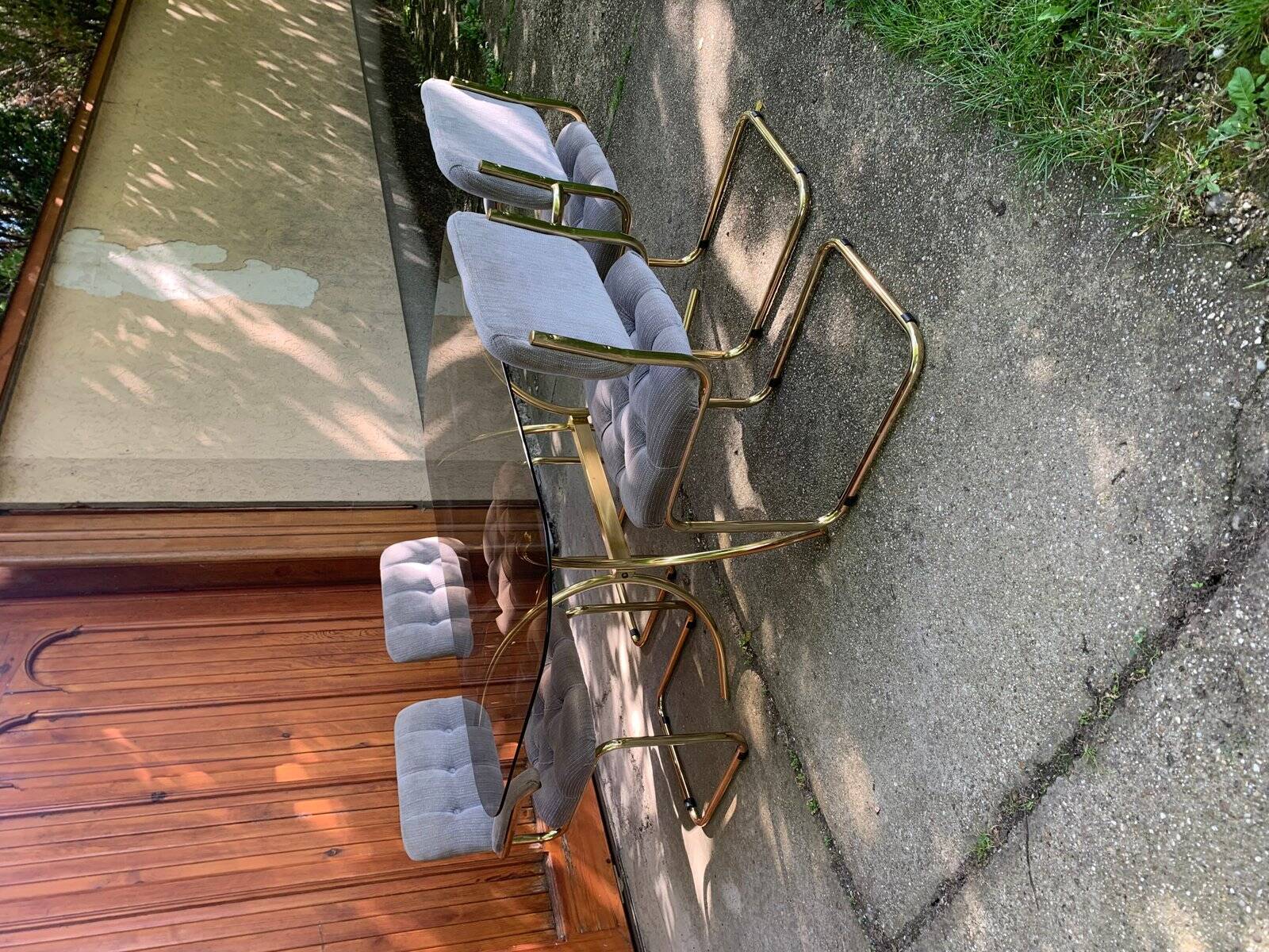 1970s table set with 4 chairs in gold brass and grey fabric, smoked glass top.