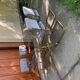 1970s table set with 4 chairs in gold brass and grey fabric, smoked glass top.