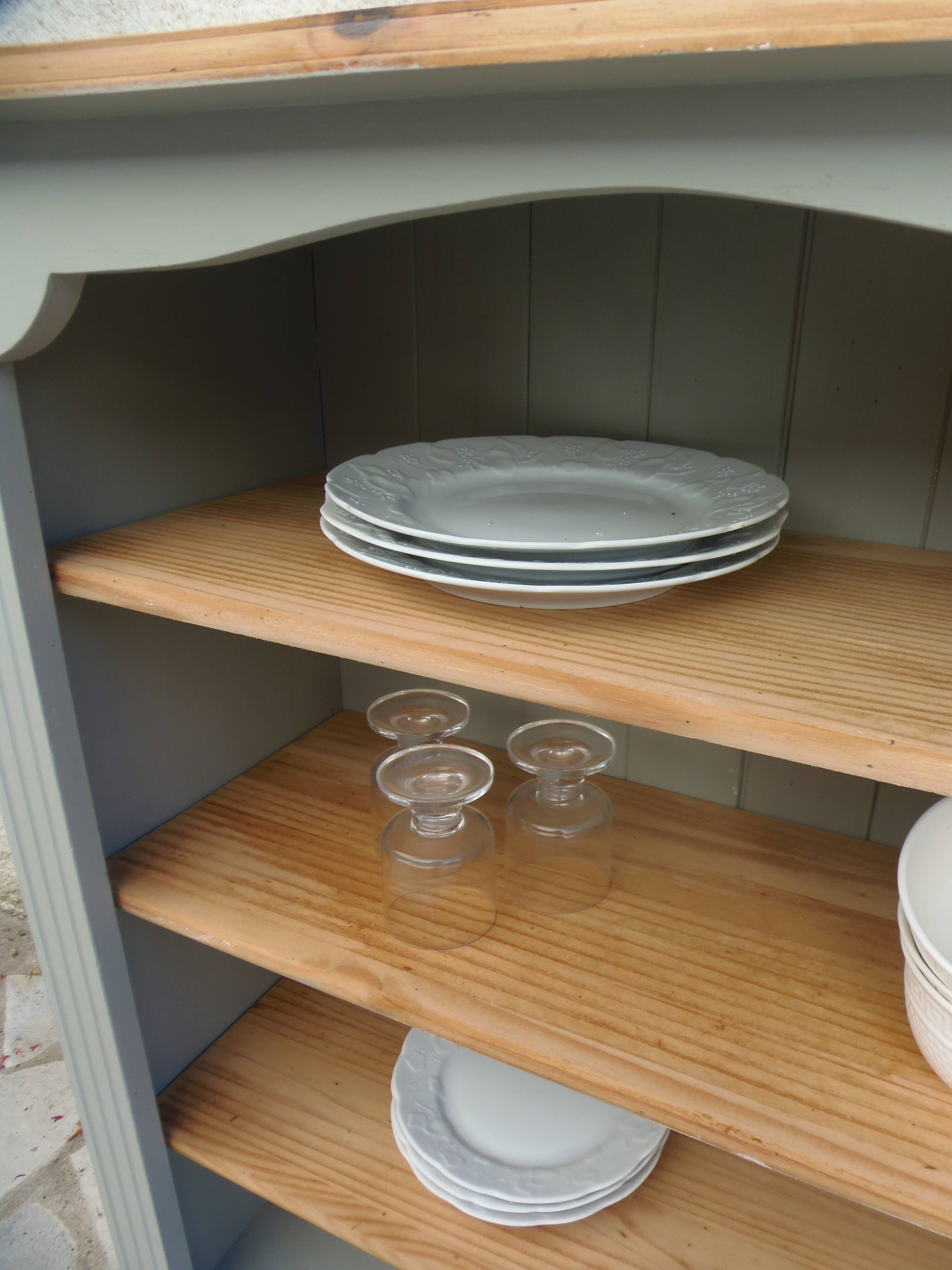 Green-grey library, wooden shelf and shelves in natural wood.