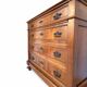 Antique walnut commode with bronze handles in the shape of a lion's mask,