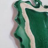 empty green ceramic pocket cup, small chips on the edges, signed