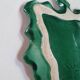 empty green ceramic pocket cup, small chips on the edges, signed