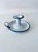 Old candle holder in white enameled metal