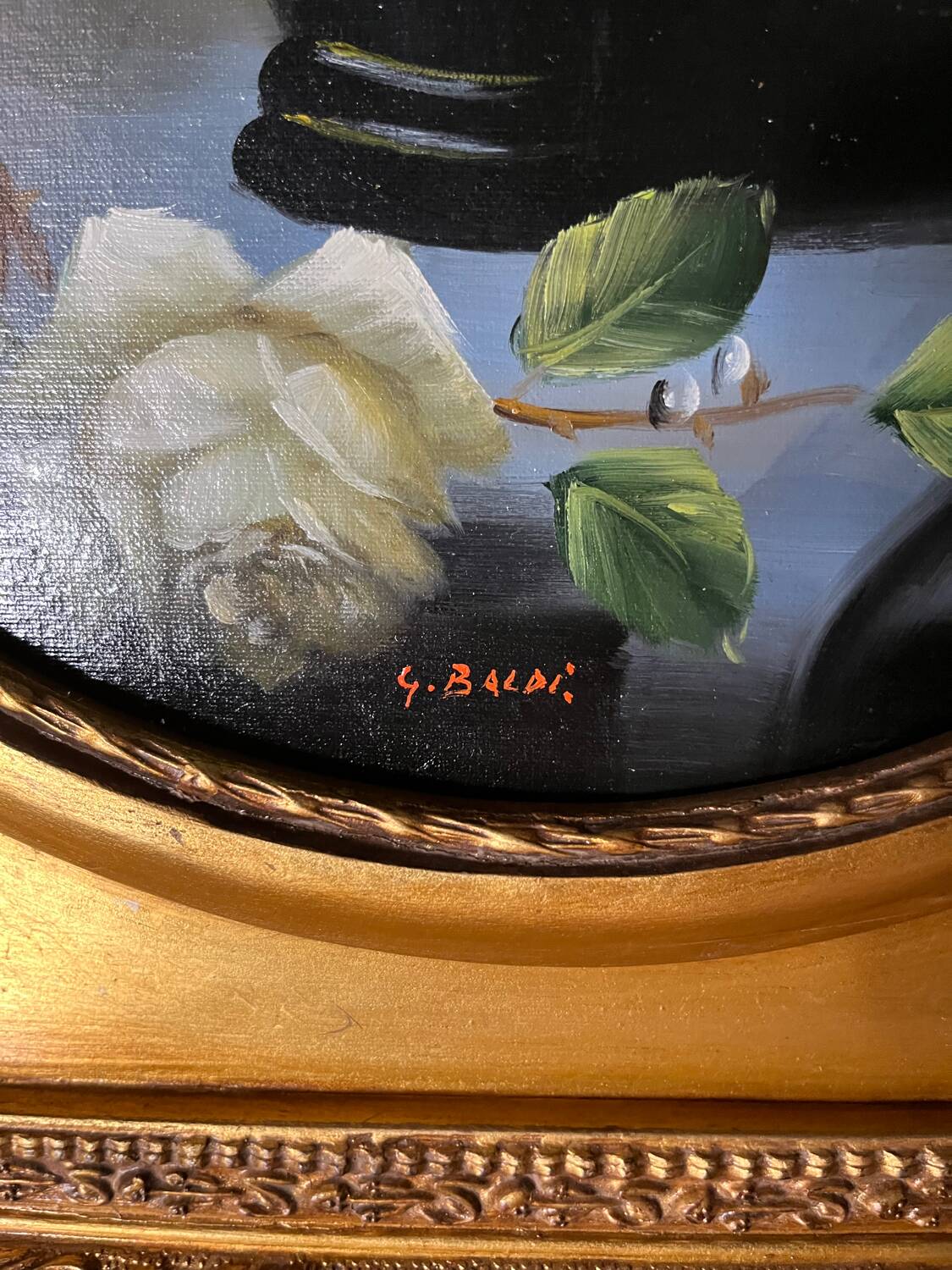 Large still life with white roses in an old gilded oval frame.