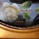 Large still life with white roses in an old gilded oval frame.