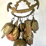 Wall decoration of brass and wood amulets