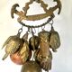Wall decoration of brass and wood amulets